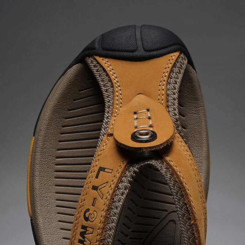 Close-up of casual men's genuine leather anti-slip flip-flops with durable rubber sole, perfect for any season. Model SF1068.